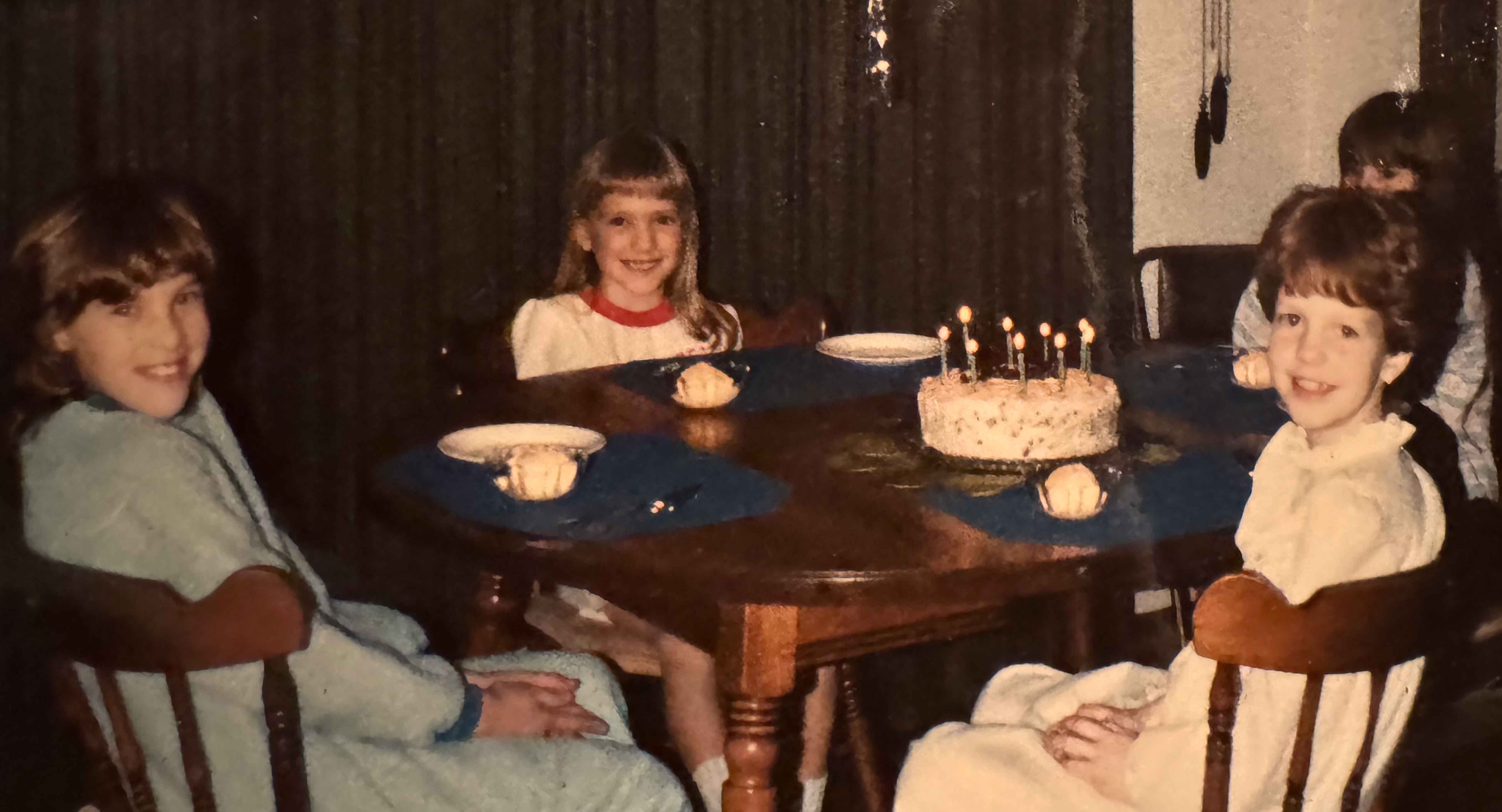 Girls sitting around the table celebrating a birthday